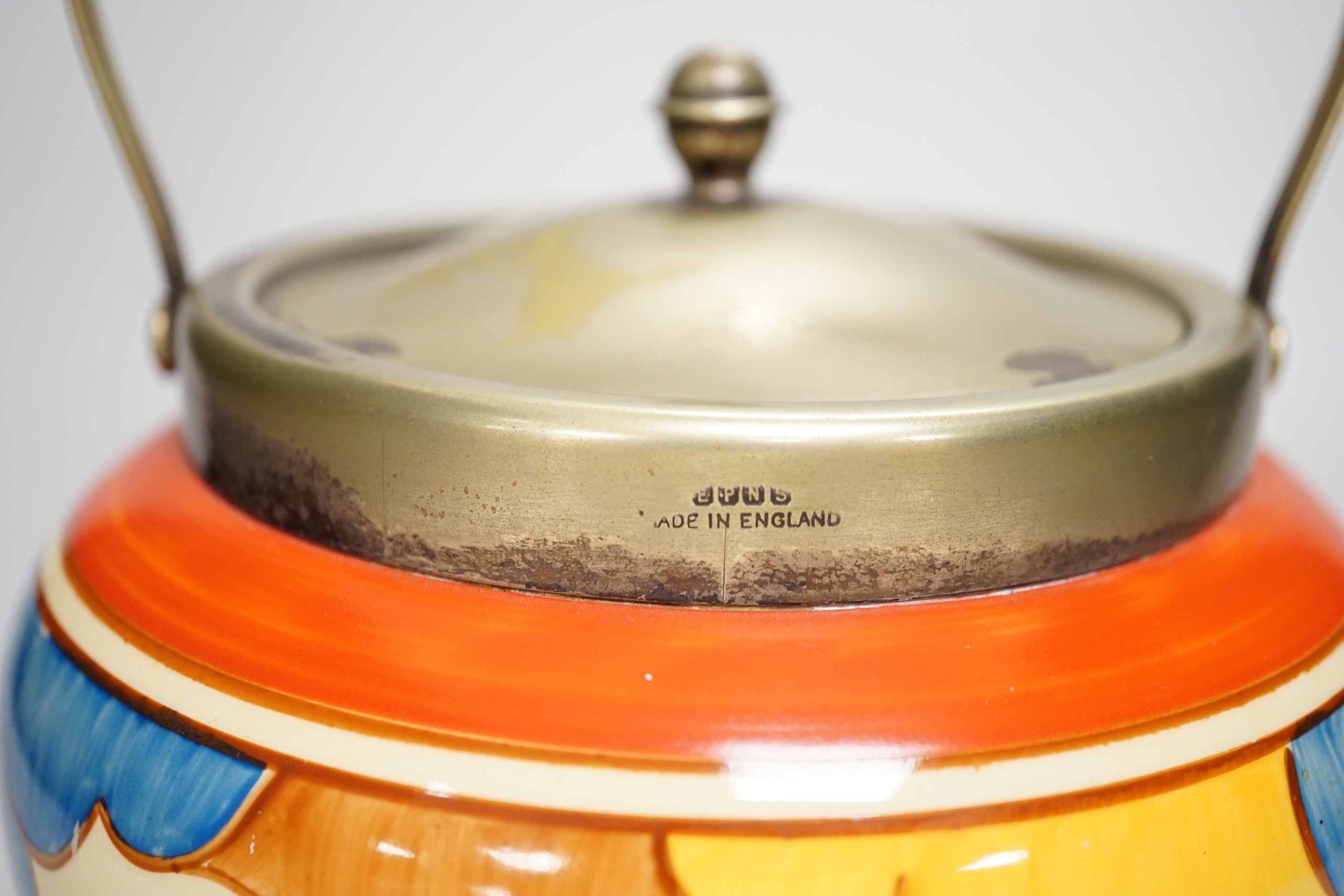 A Clarice Cliff biscuit jar, Blue Autumn, c.1931 with silver plated lid and swing handle, 21cm high